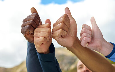 Buy stock photo Closeup shot of a group of unrecognisable people showing thumbs up while exercising outdoors