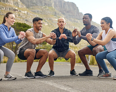 Buy stock photo Shot of a group of sporty young people doing squats while exercising together outdoors