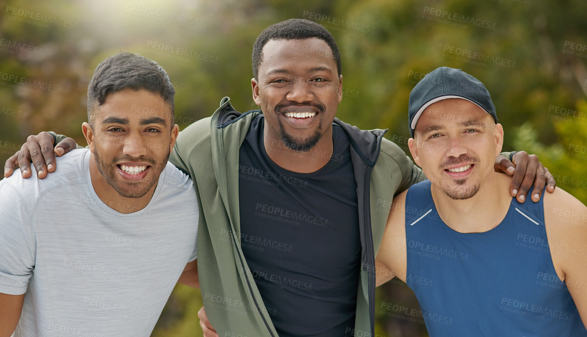 Buy stock photo Portrait of a group of sporty young men standing together in a huddle while exercising outdoors