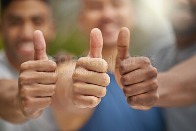 Buy stock photo Closeup shot of a group of unrecognisable men showing thumbs up while exercising outdoors