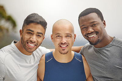 Buy stock photo Portrait of a group of sporty young men standing together in a huddle while exercising outdoors