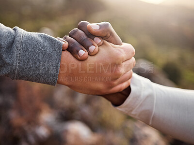 Buy stock photo Cropped shot of an unrecognizable man helping his friend along a mountain during their hike