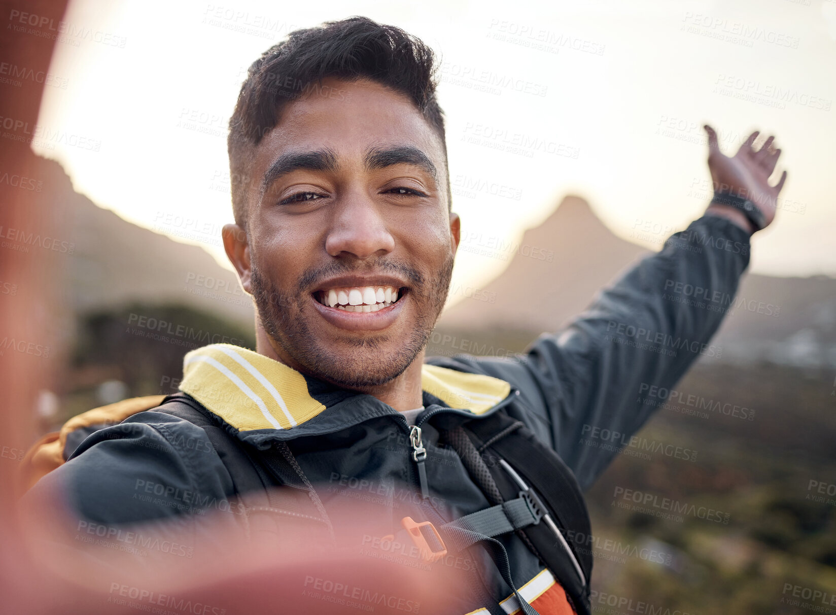 Buy stock photo Cropped portrait of a handsome young man taking selfies while hiking in the mountains