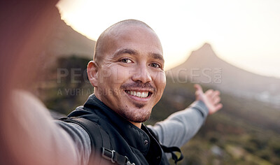 Buy stock photo Cropped portrait of a handsome young man taking selfies while hiking in the mountains