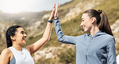 Buy stock photo Shot of two women sharing a high-five while out for a workout