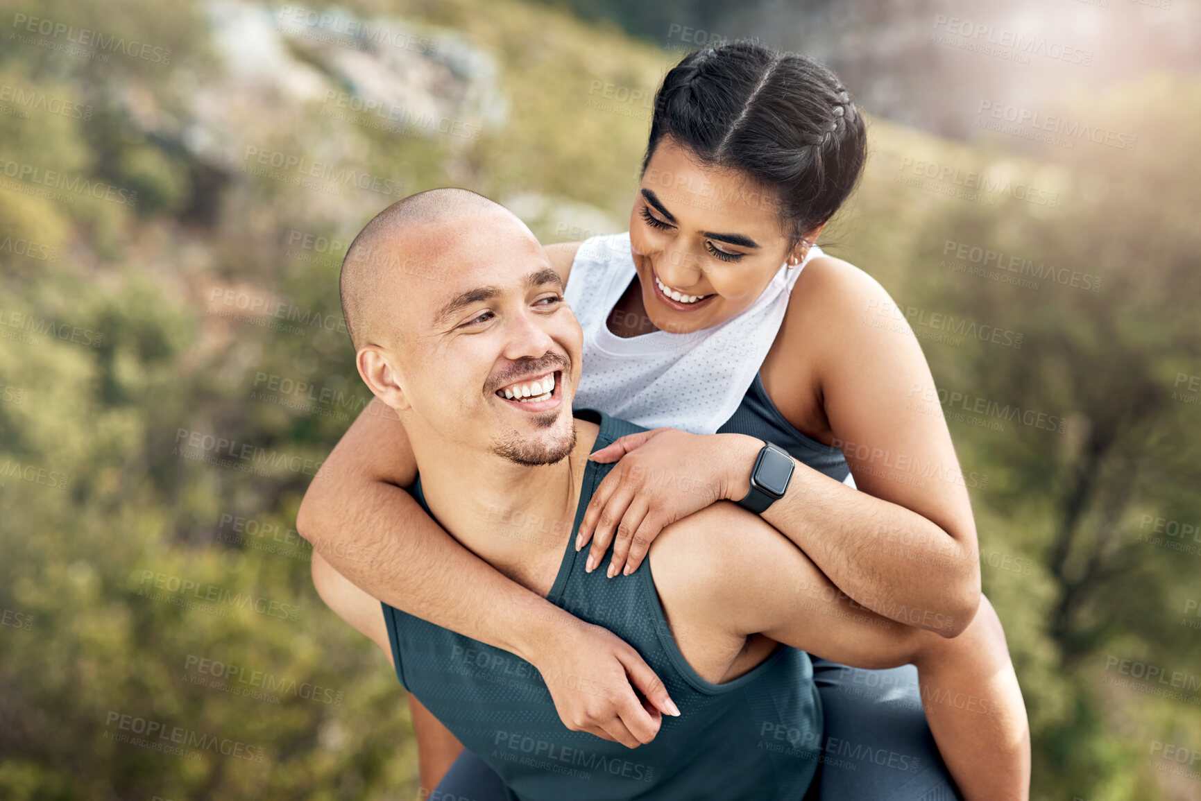 Buy stock photo Shot of a man carrying his girlfriend on his back while out for a workout