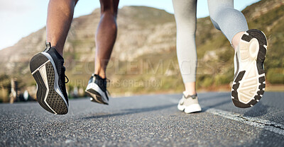 Buy stock photo Cropped shot of a couple out for a run on a mountain road
