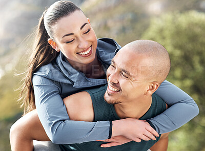 Buy stock photo Shot of a man carrying his girlfriend on his back while out for a workout