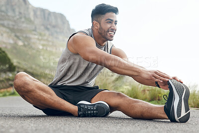 Buy stock photo Shot of an athletic young man stretching on a mountain road