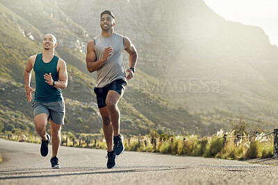 Buy stock photo Shot of two men out for a run on a mountain road