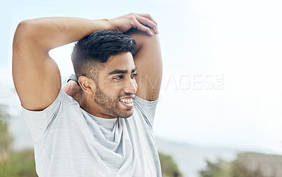 Buy stock photo Shot of a handsome young man stretching outside