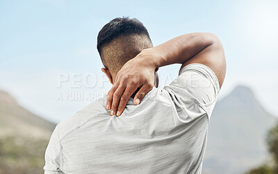 Buy stock photo Shot of a sporty young man experiencing discomfort in his neck while out for a run