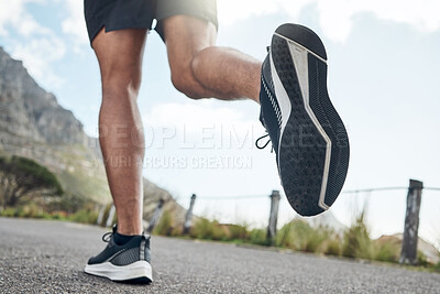 Buy stock photo Cropped shot of a man running on a mountain road