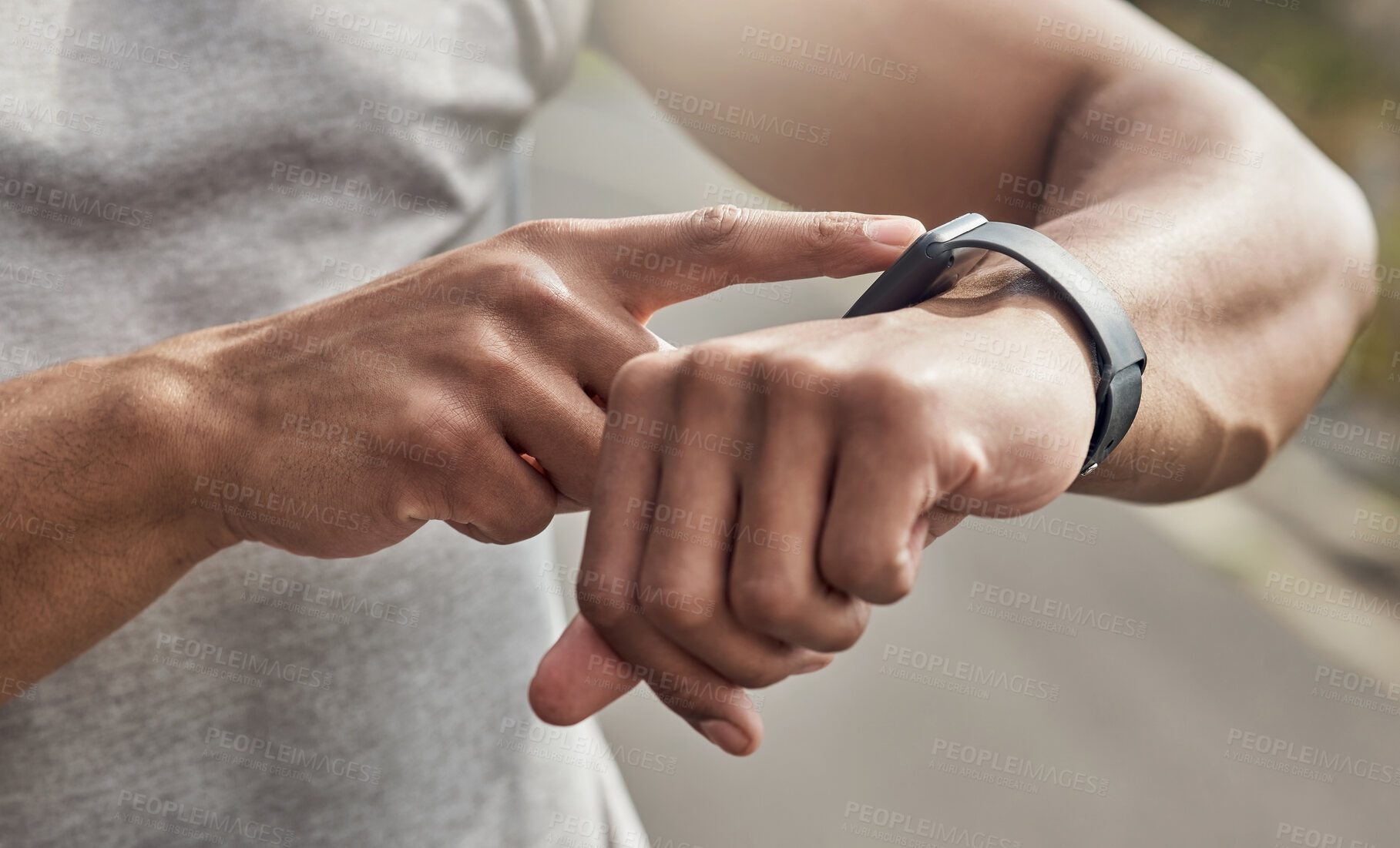 Buy stock photo Cropped shot of a man checking his watch while out for a run