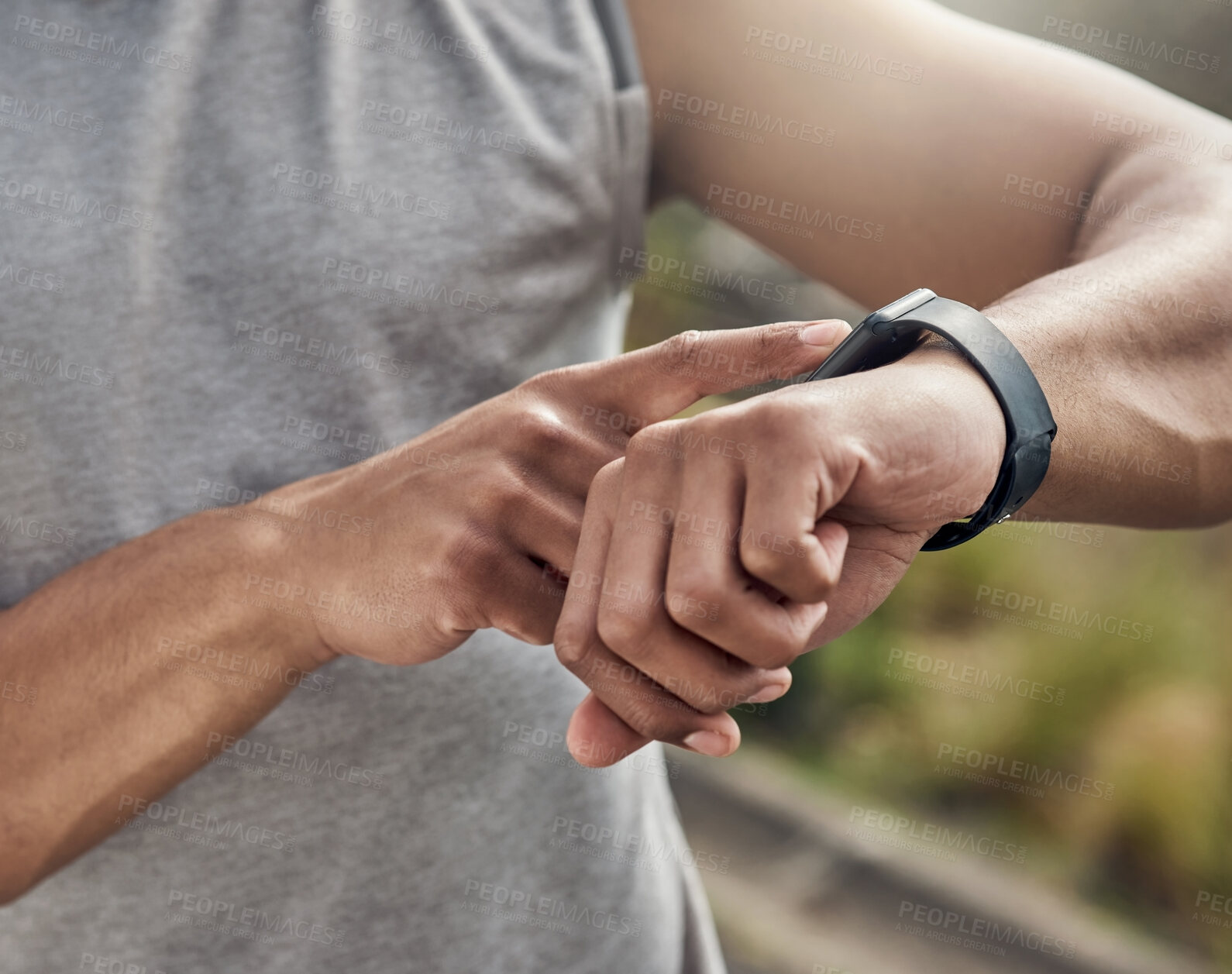 Buy stock photo Cropped shot of a man checking his watch while out for a run