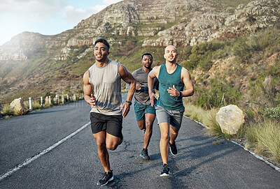 Buy stock photo Shot of three men out for a run on a mountain road