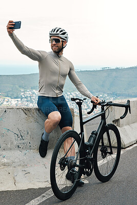 Buy stock photo Full length shot of a handsome mature man taking a break to snap some selfies while cycling outdoors