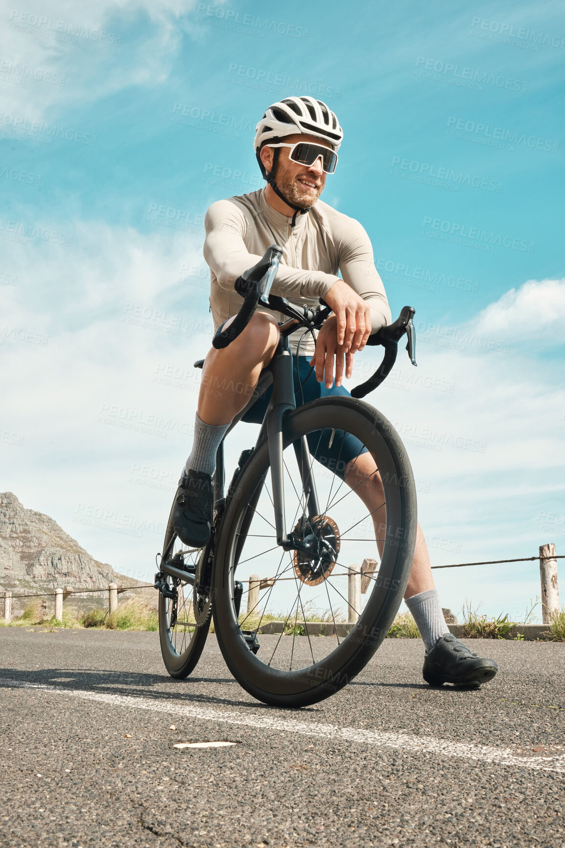 Buy stock photo Full length shot of a handsome mature man taking a break while cycling outdoors