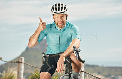 Buy stock photo Cropped portrait of a handsome mature man giving thumbs up while cycling outdoors