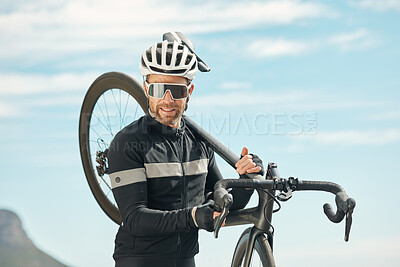 Buy stock photo Cropped portrait of a handsome mature man carrying his bike while cycling outdoors