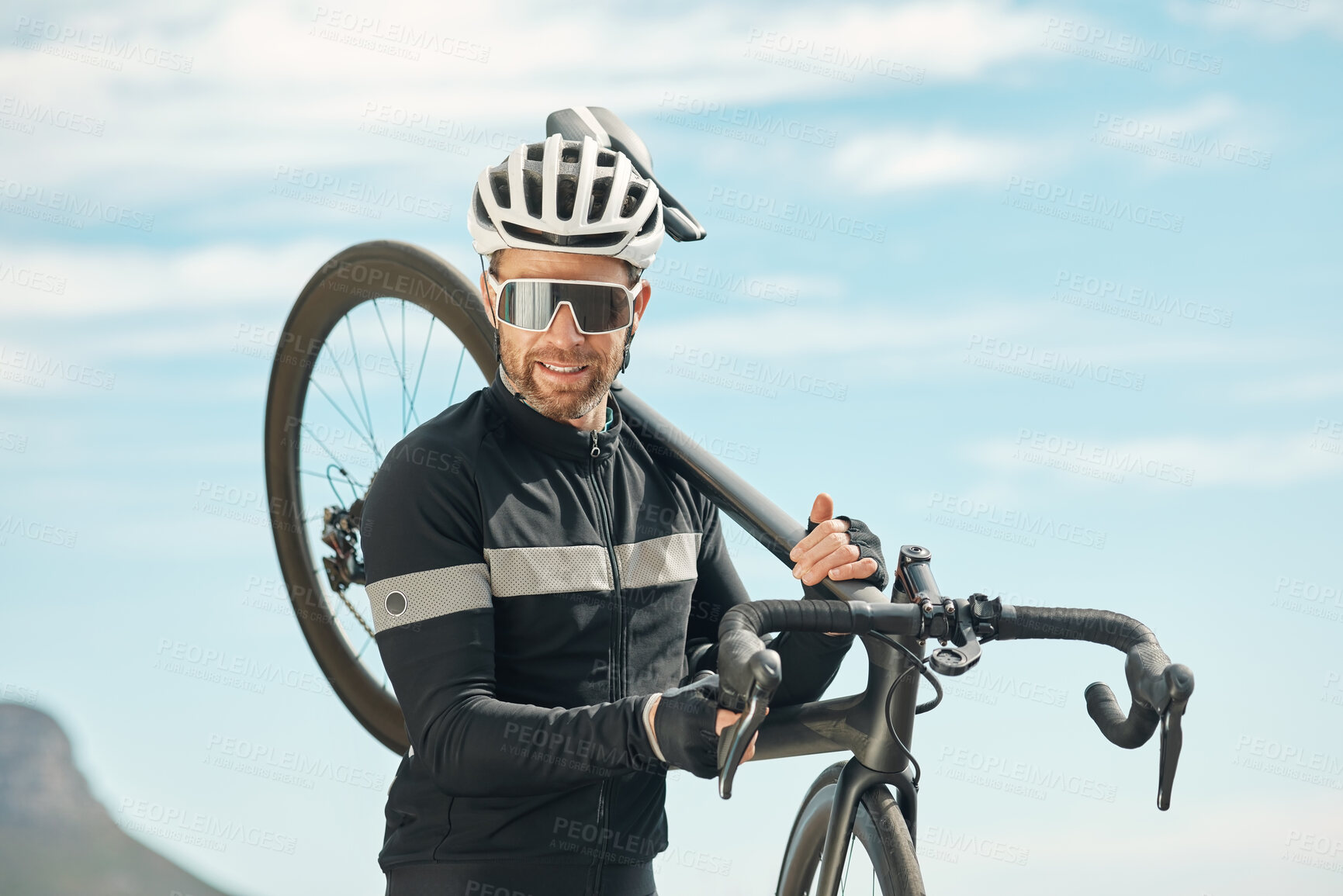 Buy stock photo Cropped portrait of a handsome mature man carrying his bike while cycling outdoors