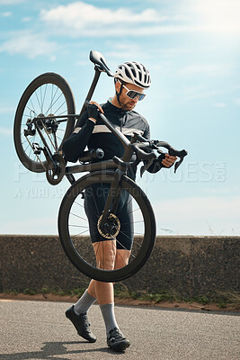 Buy stock photo Full length shot of a handsome mature man carrying his bike while cycling outdoors