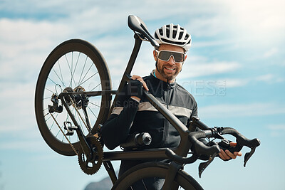 Buy stock photo Cropped portrait of a handsome mature man carrying his bike while cycling outdoors