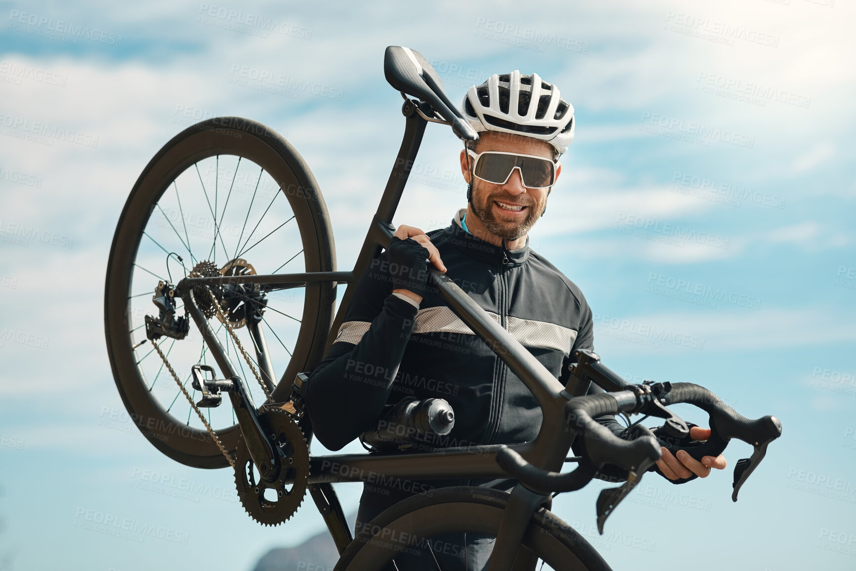 Buy stock photo Cropped portrait of a handsome mature man carrying his bike while cycling outdoors