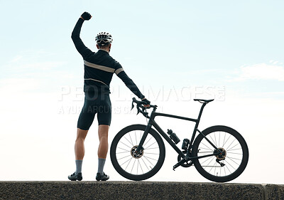 Buy stock photo Rearview shot of an unrecognizable man cheering and admiring the view while cycling outdoors