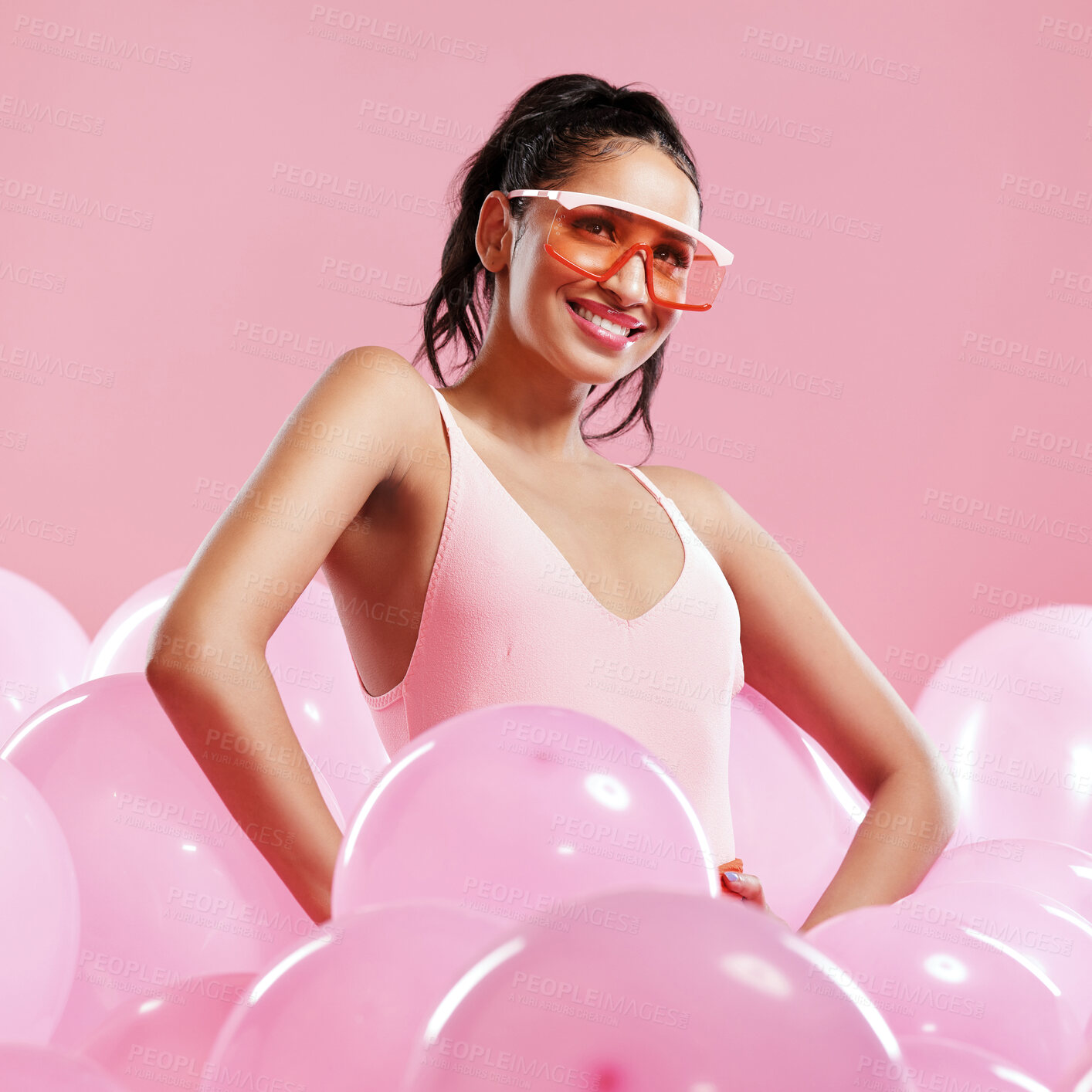 Buy stock photo Studio shot of a beautiful young woman posing with balloons