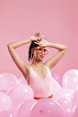 Buy stock photo Studio shot of a beautiful young woman posing with balloons