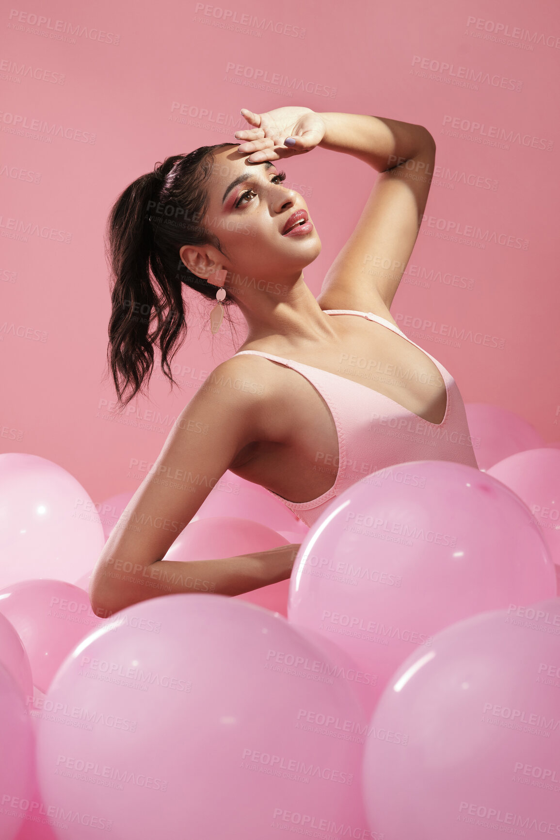 Buy stock photo Studio shot of a beautiful young woman posing with balloons