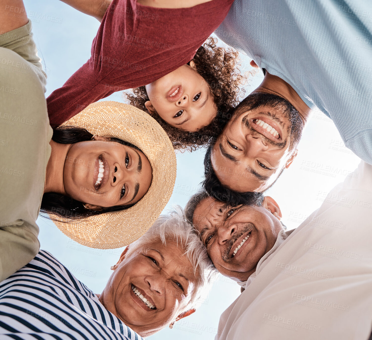 Buy stock photo Shot of a multi-generational family spending the day at the beach