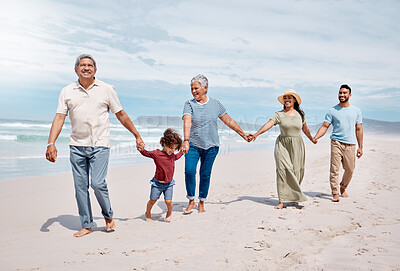 Buy stock photo Shot of a multi-generational family spending the day at the beach