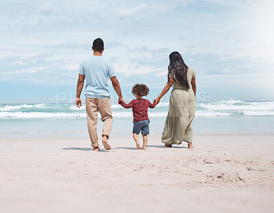 Buy stock photo Shot of a little walking on the beach with his parents