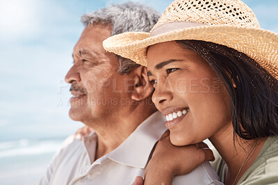 Buy stock photo Shot of a young woman spending the day at the beach with her elderly father