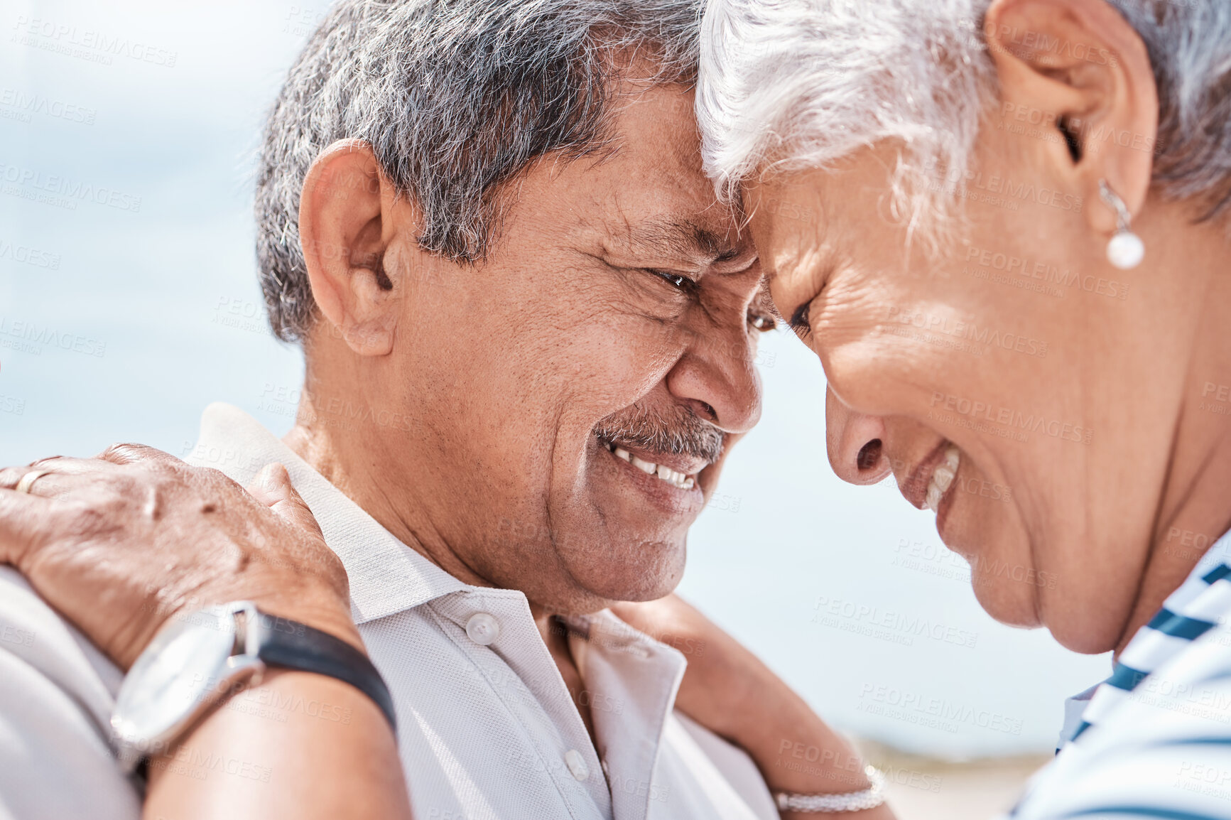 Buy stock photo Old couple, affection and touch with forehead at beach with smile, care or bonding on summer vacation. Elderly man, happy woman and trust with loyalty, relationship and retirement on seaside holiday