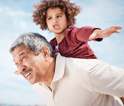 Buy stock photo Shot of a senior man at the beach with his grandson