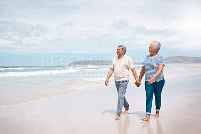 Buy stock photo Shot of a senior couple taking a walk on the beach