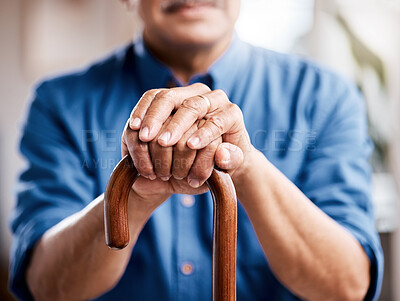 Buy stock photo Shot of a senior man leaning in his walking stick at home