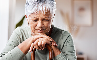 Buy stock photo Shot of a senior woman leaning in her walking stick at home