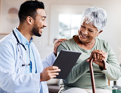 Buy stock photo Shot of a young doctor sharing information from his digital tablet with an older patient