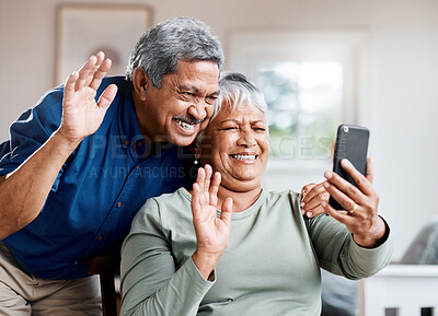 Buy stock photo Shot of a happy senior couple on a video call together at home