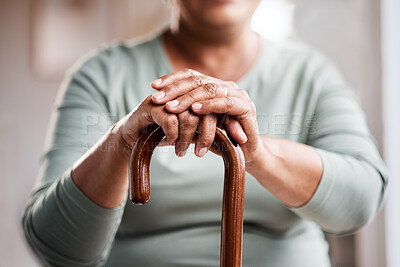Buy stock photo Shot of an unrecognizable senior woman leaning in her walking stick at home