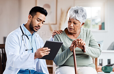Buy stock photo Shot of a young doctor sharing information from his digital tablet with an older patient