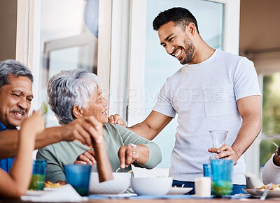 Buy stock photo Shot of a happy family having lunch together at home