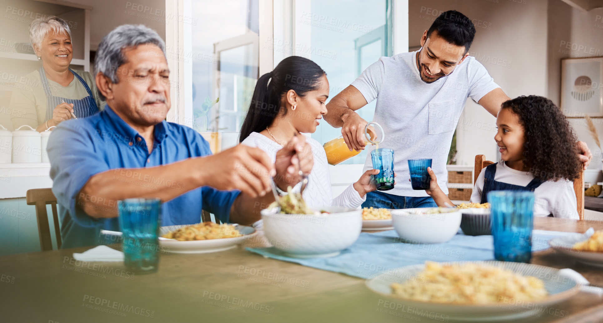 Buy stock photo Shot of a happy family having lunch together at home