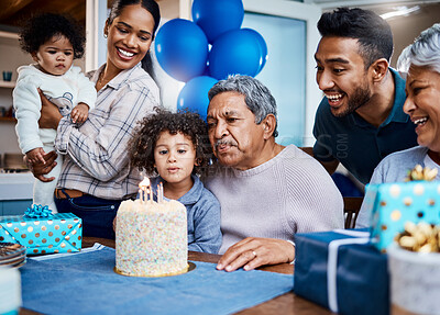 Buy stock photo Shot of a little boy celebrating his birthday with his family at home
