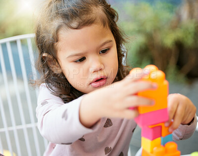 Buy stock photo Child, playing and building blocks for motor skills for growth, youth development and learning in garden. Toddler, girl and colorful puzzle for education, skill and memory with cognition, fun or toys