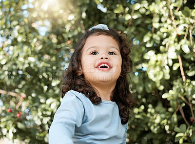 Buy stock photo Child, happy and positive in playground, backyard or park for fun, joy and development as toddler. Girl, kid and cheerful in outdoor with growth, learning and physical activity for adventure as youth